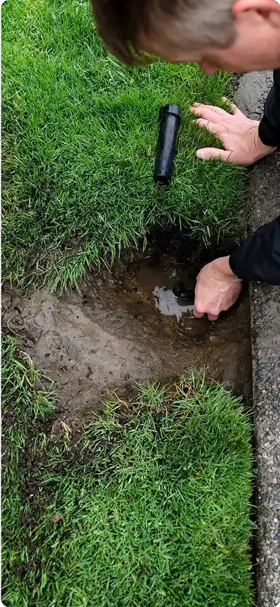 Close-up of an irrigation repair expert doing work on an irrigation system. Close-up of an irrigation repair expert doing work on an irrigation system.