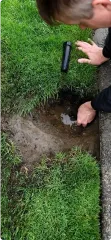 Close-up of an irrigation repair expert doing work on an irrigation system. Close-up of an irrigation repair expert doing work on an irrigation system.