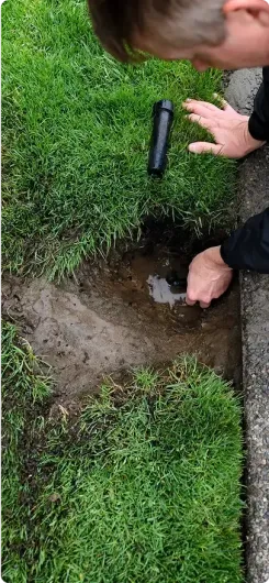 Close-up of an irrigation repair expert doing work on an irrigation system. Close-up of an irrigation repair expert doing work on an irrigation system.
